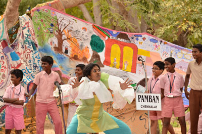 Sangeeta performing with children